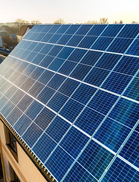 aerial-view-new-modern-two-story-house-cottage-with-blue-shiny-solar-photo-voltaic-panels-system-roof-renewable-ecological-green-energy-production-concept